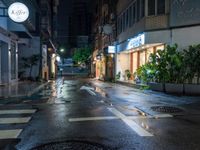 an empty wet city street at night during the day time with rain pouring on the ground