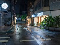 an empty wet city street at night during the day time with rain pouring on the ground