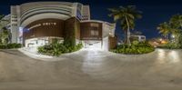 a skateboarder rides up the side of the ramp of a building with a palm tree and plant