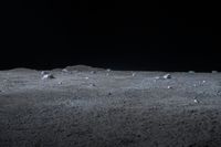 a scene of some rocks on the surface of a barren area in the night sky