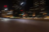 an image of street at night from inside the car window with blurry lights on