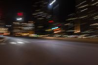 an image of street at night from inside the car window with blurry lights on