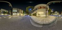 a 360 - view of a street intersection at night with the city lights off and buildings behind it