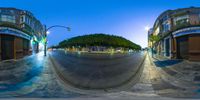 a fish eye view of an empty street at night with no cars and buildings visible