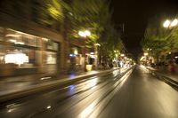 motion bluring image of street at night in city, as seen from a moving car