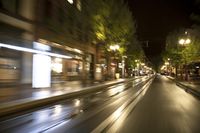 motion bluring image of street at night in city, as seen from a moving car