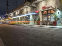 a long exposure photo of a restaurant that is located on the side of the street