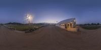 an image of a small building in the dark of night time with multiple mirrors on it