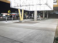 there is a sign that reads bus stop at night time and street signs on the side