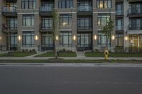 a person on a sidewalk in front of a building at night in canada outside of toronto