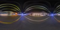 an artistic photograph of a bunch of blurry circles on the street at night and light trails