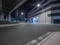 a building is shown at night with no lights on it's sides or sidewalks