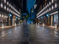 a large brick sidewalk with a store front at night time and a sign that says