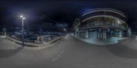 a fish eye view of a city with a ramp near by at night time from above a skateboard ramp