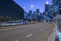 the street that runs alongside the road is empty as if for the cars, vehicles and people