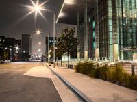 a long walk leads to a parking space next to an office building at night in the city