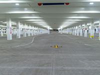 a parking lot with lots of empty parking lots and yellow arrows indicating a pointy exit