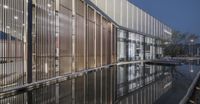 a modern architecture shot of an outdoor area, at night with glass and metal panels