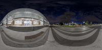 a fisheye lens looking into a building at night time and the reflection on it is made