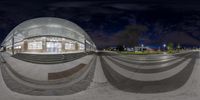 a fisheye lens looking into a building at night time and the reflection on it is made