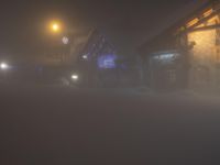 the town lights shine brightly on a foggy, cold winter night in the area