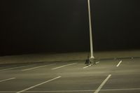 Night Time Street in a City with Parking Lot and Stadium