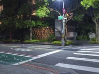 traffic lights are lit up on the side of a street with a sidewalk and bicycle lane