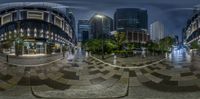 two circular fisheye photographs show people walking through a city street at night time, one with a camera facing the other