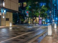 a large brick sidewalk with a store front at night time and a sign that says