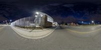 the view from a fish eye lens on a street corner in the city at night