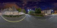 a 360 - lens view of a modern building in a city at night time with streetlights