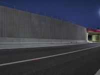 a long exposure shot of a tunnel at night with no headlights, it is very empty