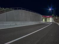 a long exposure shot of a tunnel at night with no headlights, it is very empty