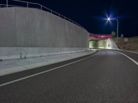 a long exposure shot of a tunnel at night with no headlights, it is very empty