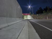 a long exposure shot of a tunnel at night with no headlights, it is very empty