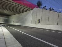 a long exposure shot of a tunnel at night with no headlights, it is very empty