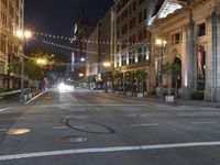 a deserted city street filled with traffic at night time at dusk, with lights on