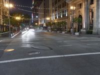 a deserted city street filled with traffic at night time at dusk, with lights on