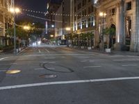 a deserted city street filled with traffic at night time at dusk, with lights on