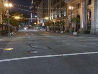 a deserted city street filled with traffic at night time at dusk, with lights on