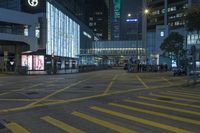 a traffic light at a busy intersection in hong city at night with pedestrians on the sidewalk