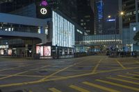 a traffic light at a busy intersection in hong city at night with pedestrians on the sidewalk