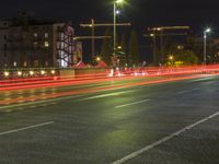 a long exposure photo shows traffic in the city at night, with lights turning red