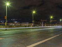 a long exposure photo shows traffic in the city at night, with lights turning red