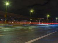 a long exposure photo shows traffic in the city at night, with lights turning red