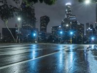 the traffic light reflects on a wet street at night as cars go by on the sidewalk