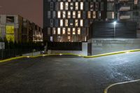 a man in the parking lot near some tall buildings on a nighttime day or night