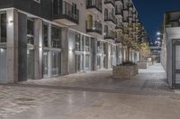 a view of the outside of an apartment building at night, showing off of the front entrance