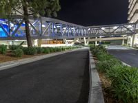 a view of a road and an overpass with traffic passing through it by buildings