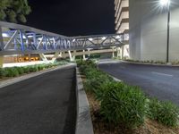 a view of a road and an overpass with traffic passing through it by buildings